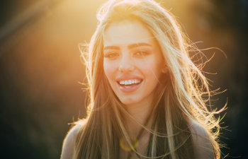 attractive blonde laughs in the sunshine